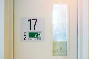 Fire Exit door sign for emergency. Stairwell fire for escape in building or apartment photo