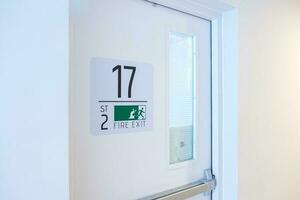 Fire Exit door sign for emergency. Stairwell fire for escape in building or apartment photo
