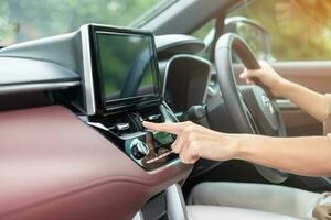 Finger presses the emergency stop button inside the car. Safety and transportation concept photo