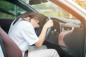 woman feeling stress and angry during drive car long time. Asian girl tired and fatigue having headache stop after driving car in traffic jam. Sleepy, stretching and drunk concept photo