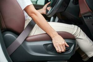 Hand adjust car seat before drive on the road . Ergonomic and safety transportation concept photo