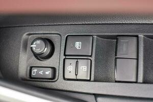 buttons controlling the windows inside a car, control and electric mirror adjustment photo