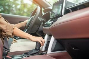 woman driver stick shift transmission a car gear, hand controlling steering wheel during vehicle moving. Journey, trip and safety Transportation concepts photo