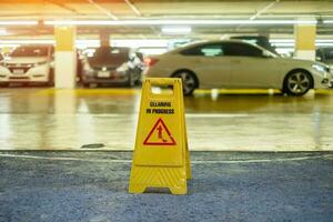Sign showing warning of caution wet floor in garage building photo