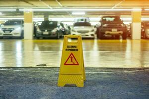 Sign showing warning of caution wet floor in garage building photo