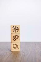 wood block with business goal, strategy, target, mission, action, objective, teamwork, brainstorm and idea concept photo