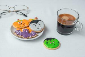 hot espresso coffee  or chocolate cup with funny Halloween Cookies. Happy Halloween day, Trick or Threat, Hello October, fall autumn, Traditional, party and holiday concept photo