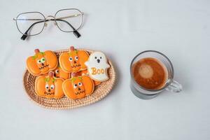 hot espresso coffee  or chocolate cup with funny Halloween Cookies. Happy Halloween day, Trick or Threat, Hello October, fall autumn, Traditional, party and holiday concept photo