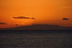 picturesque ocean landscape with the setting sun in a tropical country during summer holidays photo