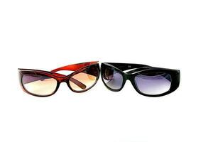 fashionable two pairs of colored sun glasses on white isolated background photo