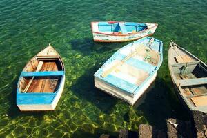 view of the wooden small boats standing in the harbor on the Spanish island of Lanzarote in the city of Arrcecife photo