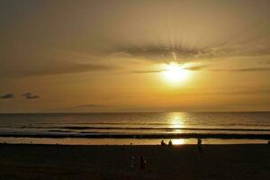 picturesque ocean landscape with the setting sun in a tropical country during summer holidays photo