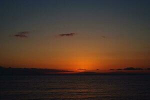 picturesque ocean landscape with the setting sun in a tropical country during summer holidays photo