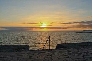 picturesque ocean landscape with the setting sun in a tropical country during summer holidays photo