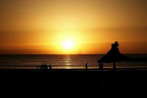 picturesque ocean landscape with the setting sun in a tropical country during summer holidays photo