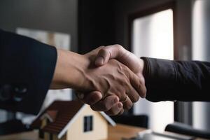 Real estate agent shaking hands with customer after signing contract for buying a house. Real estate broker manager shaking hands, photo