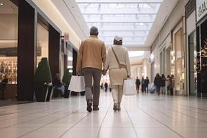 Back view of a senior couple walking with shopping bags in the shopping mall,Husband and wife full rear view walking in a shop photo