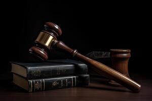 Wooden gavel and books on a black background. Law concept. Legal law hammer on a table with law books, photo