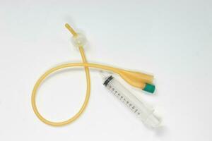 Urinary catheter with syringe 10 ml on a white background, test photo