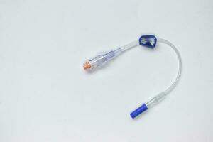 Extension tube with connector for intravenous catheter on white photo