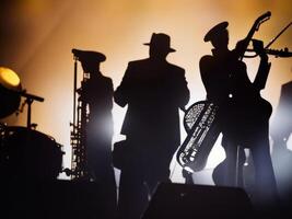 Silhouette of a musicians playing jazz. photo