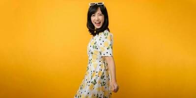 Portrait cheerful young asian woman happy smile dressing springtime female style fashion isolated on yellow background. attractive pretty model girl posing emotion summertime concept. photo