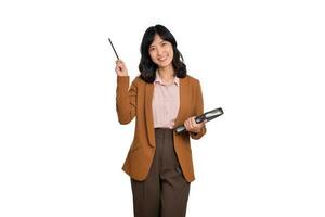 Happy young asian business woman holding notepad and pointing pencil up isolated on white background photo