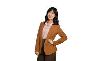 Young asian woman, professional businness entrepreneur in brown suit with hand on hip and smile isolated over white background photo