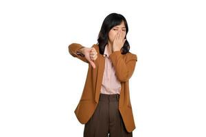 Dislike. Disgusted asian woman showing thumbs down and grimacing, commenting on smth bad, disagree, complaining, standing over white background photo