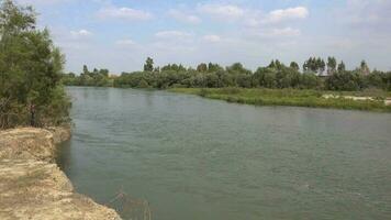 Large River Surrounded by Soil and Trees in Flat Plain video