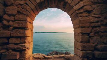 , historic medieval stone arch windows with romantic view of sea or ocean, summer landscape background. photo