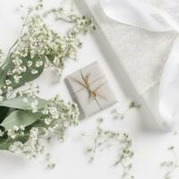 wedding desktop mockup with baby's breath Gypsophila flowers, dry green eucalyptus leaves, satin ribbon and white background, , generat ai photo