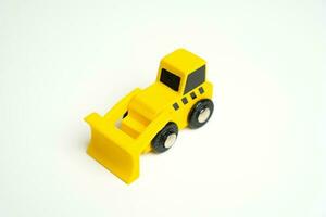 Yellow toy bulldozer, top view copy space. Demolition services, land leveling and other land works. Take down Illegal buildings. Industry machinery for rent photo