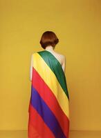 Girl wearing rainbow flag. Concept of LGBT pride. . photo