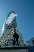 Transsexual girl protesting by waving the flag for gender freedom photo