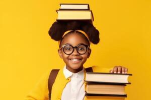 funny smiling Black child school girl with glasses hold books on her head. Yellow background. photo