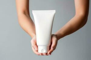 woman hands holding cosmetic cream white plastic tube mockup front view. AI Generative photo