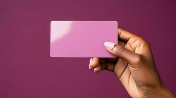 Close up of female hand holding blank business card over pink background. Generative AI. photo