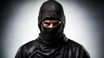 Masked thief in balaclava isolated on background. . photo