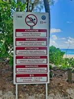Mahe Seychelles 15.06.23 Swim with caution sign near the beach of intendance, due to rough sea photo