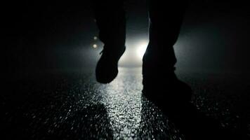 Person walking outside on dark spooky street at night video