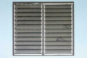 Dust clinging on a louver window that have never been cleaned affecting the health of residents. photo