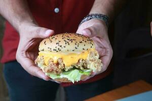 Zinger burger or Crispy chicken burger... Ultra-crispy chicken fillets are sandwiched between soft burger buns with crunchy lettuce, mayo photo