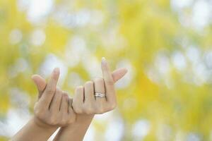 beautiful two finger mini heart of gril showing love finger shape heart closeup on green bokeh backgr photo