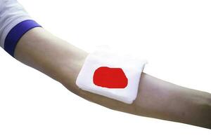 First aid training to wrap the wound around  arm with bandage on arm to stop the bleeding photo