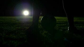 Sports person training with soccer ball on soccer field in slow motion video