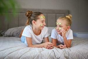 Beautiful girl with facial mask of cucumber. photo