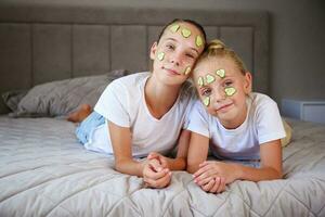 Beautiful girl with facial mask of cucumber. photo