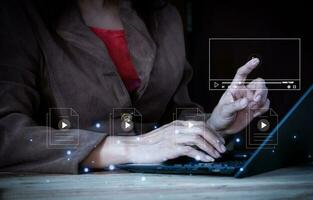 woman using computor notebook for streaming online on virtual screen, watching video on internet, live concert, show or tutorial, content online. photo