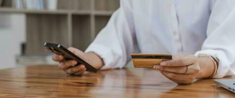 Close up of woman hand using mobile smart phone payments and credit card for online shopping,Online shopping, digital banking, E-commerce concept. photo